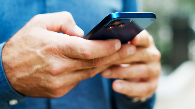 Close up of someone typing on a smartphone
