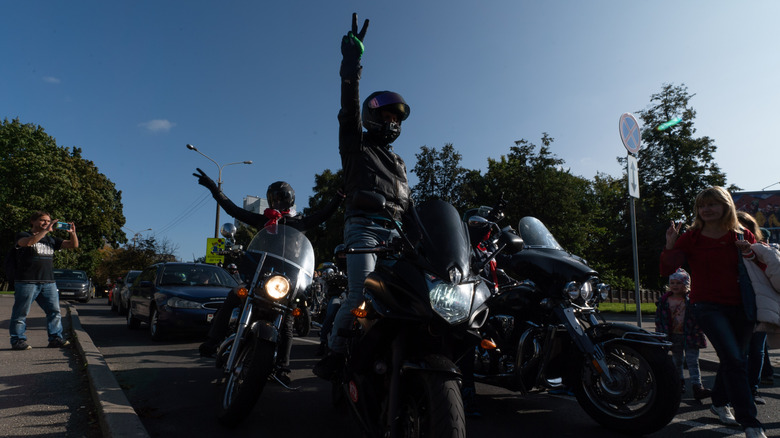 Motorcyclists showing V sign on their bikes