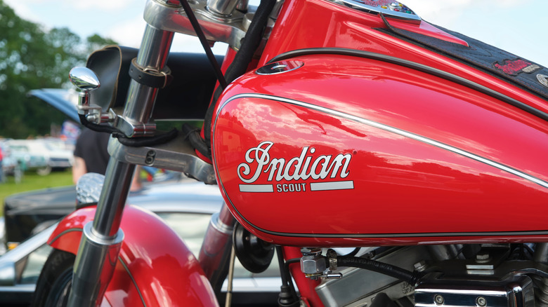 Indian Scout logo on a red tank of a classic motorcycle
