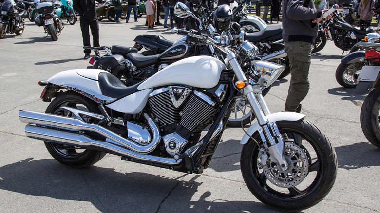 A white Victory Vegas 8-Ball chopper motorcycle with 106 cubic inch engine parked in the city