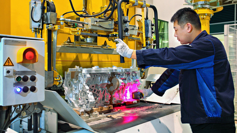 A worker assembling an engine at BMW's Shenyang plant
