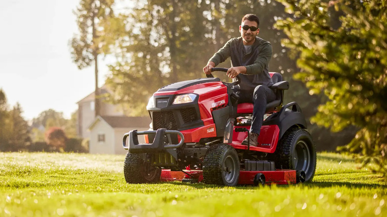Person using a Kawasaki powered Craftsman 54-Inch 24 HP Gas Riding Lawn Mower