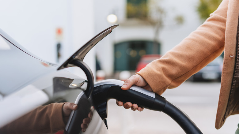 Hand holding EV charger