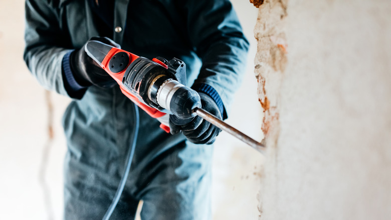 Worker drilling into a wall