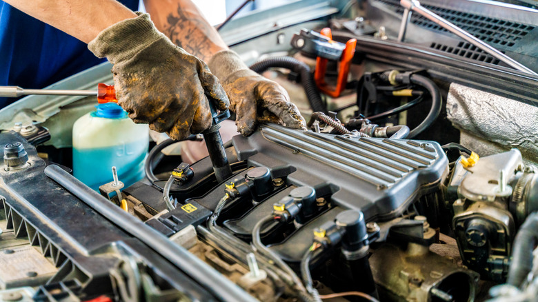 Dirty hands working on engine