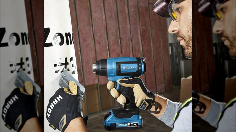 person using Hercules heat gun