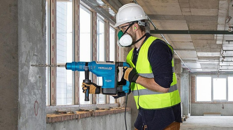 person using hercules rotary hammer drill