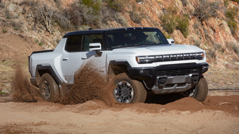 White GMC Hummer EV off-roading in sand