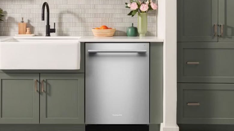 A KitchenAid dishwasher installed next to sink in a modern kitchen