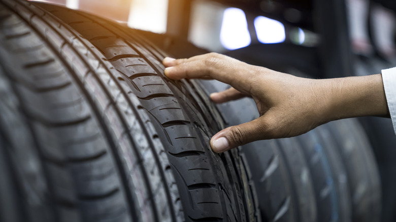 A hand checking tire