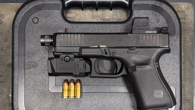 A firearm equipped with an Osight red-dot sight.