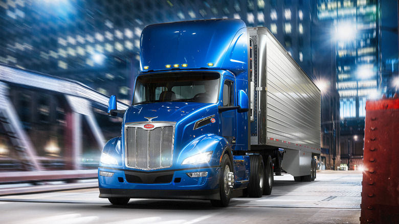 Peterbilt blue truck on city highway