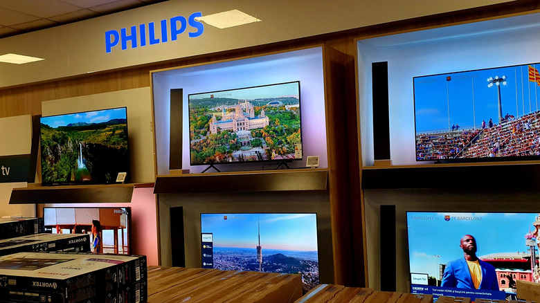 Several Philips TVs on display
