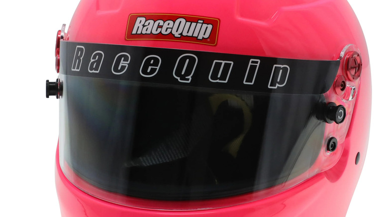Close-up of an SFI-certified RaceQuip youth full-face motorsports helmet in pink