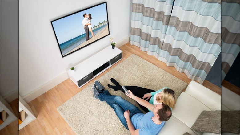 Couple watching TV from their sofa
