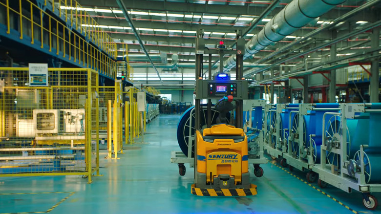 Sentury Tire automated machine carrying an in-progress tire