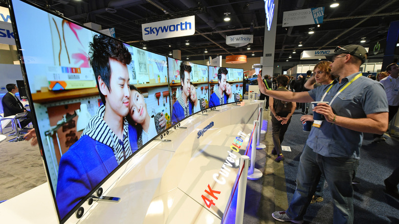 Attendees look at 65-inch Skyworth 4K curved OLED televisions on display at the 2015 International CES at the Las Vegas Convention Center on January 8, 2015 in Las Vegas, Nevada. CES, the world's largest annual consumer technology trade show.