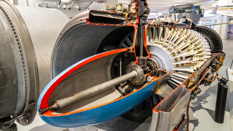 A close-up of a cross-section of a jet engine on display at a museum