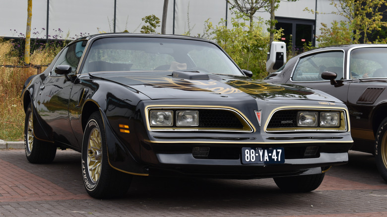 Font view of black second-generation Pontiac Trans Am parked at car show.