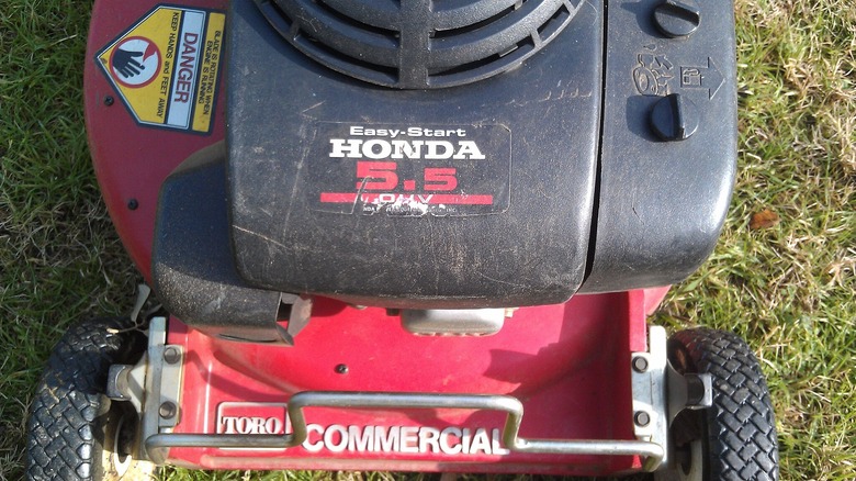 Closeup of Toro walk behind lawn mower powered by a Honda engine