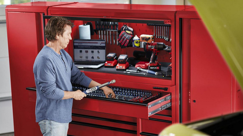 person in front of u.s. general tool cabinet