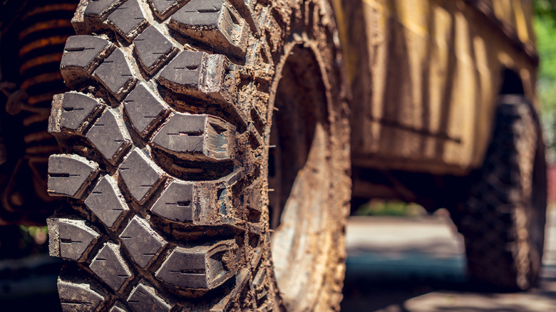 Dirty all-terrain tires on an off-road vehicle