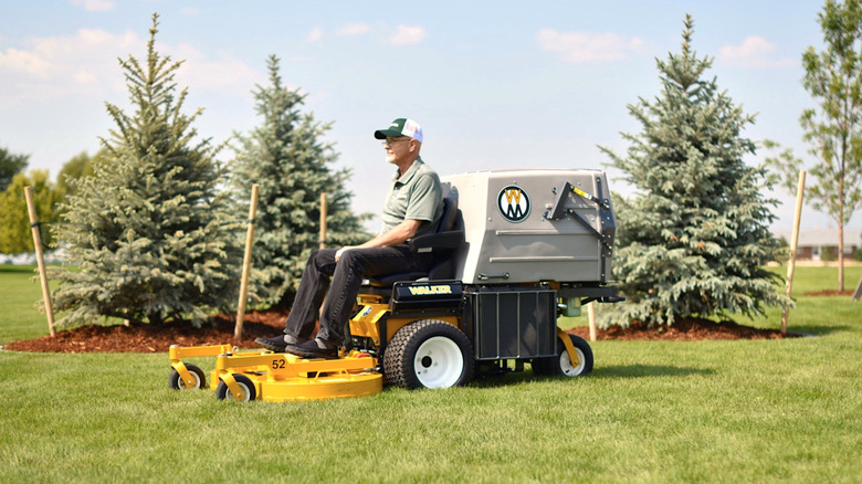 Person cutting grass with a Walker Mower