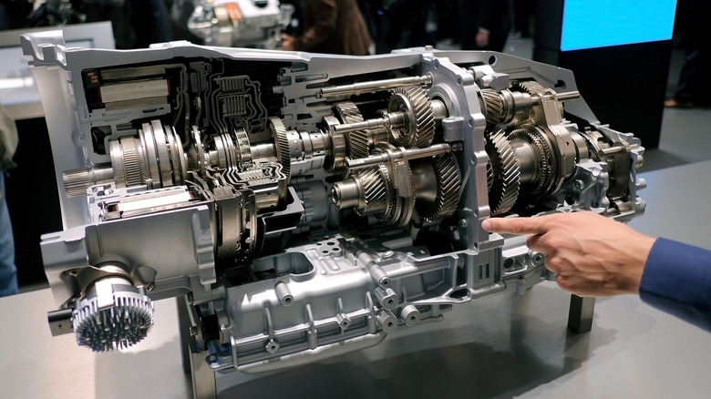 A hand pointing to an eight speed plug-in hybrid transmission at a German trade show in 2017
