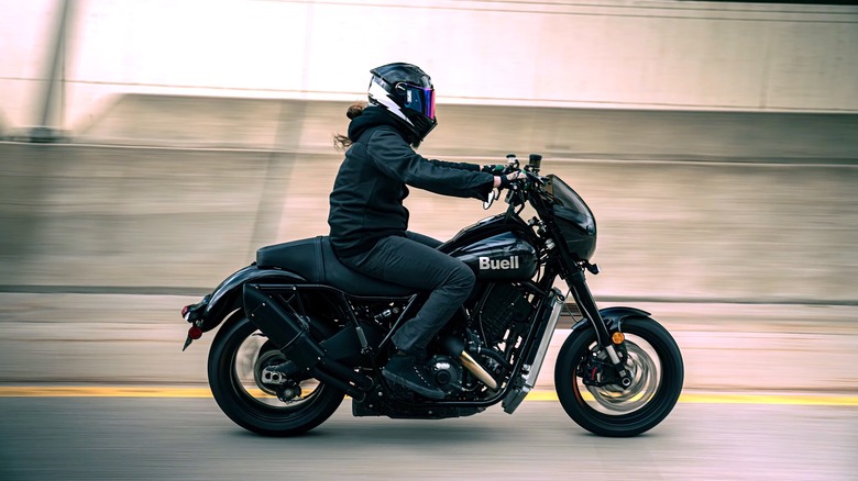 Person riding a Buell Motorcycle with blurry street background