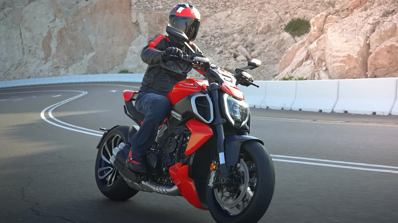 Person riding Ducati on winding road