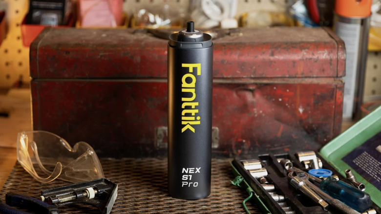 Fanttik electric screwdriver seen on a work table with tools and equipment