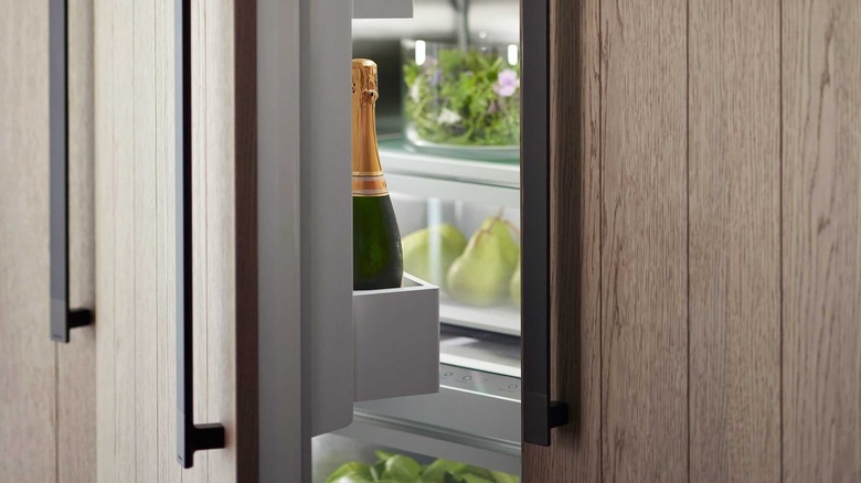 Closeup of a champagne bottle in a Fisher & Paykel refrigerator