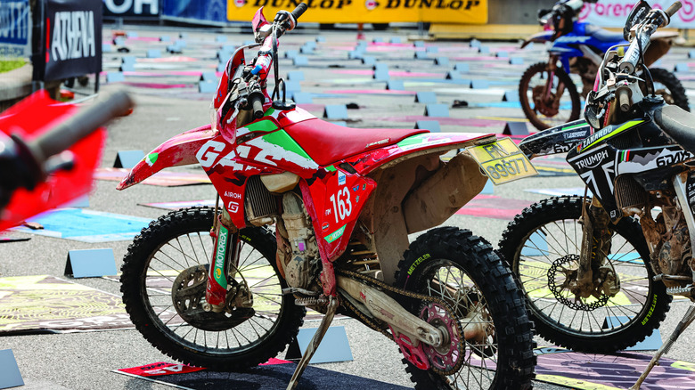A red GasGas off-road bike parked on a sunny day
