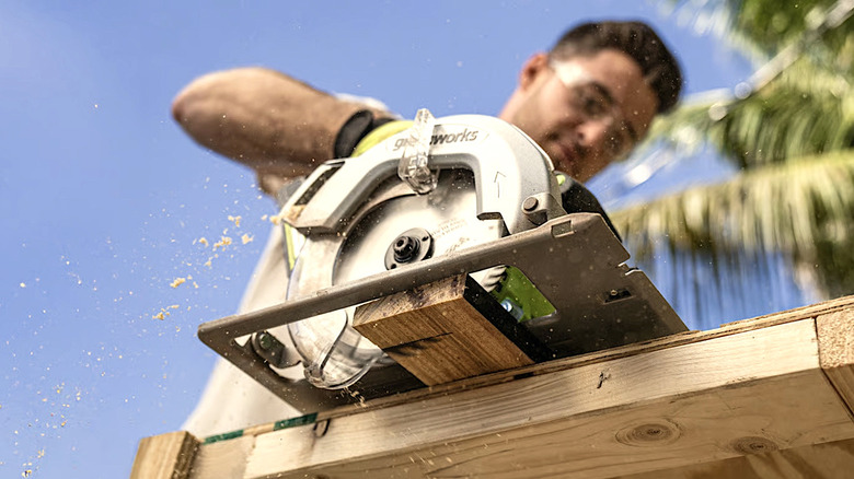 Person cutting timber with Greenworks table saw
