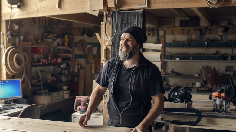 A man in a workshop full of woodworking tools