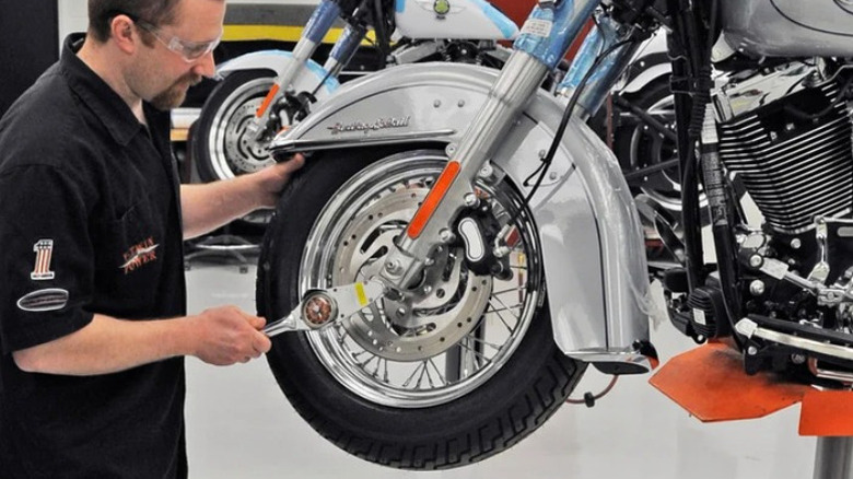 Man assembling Harley-Davidson motorcycle in factory