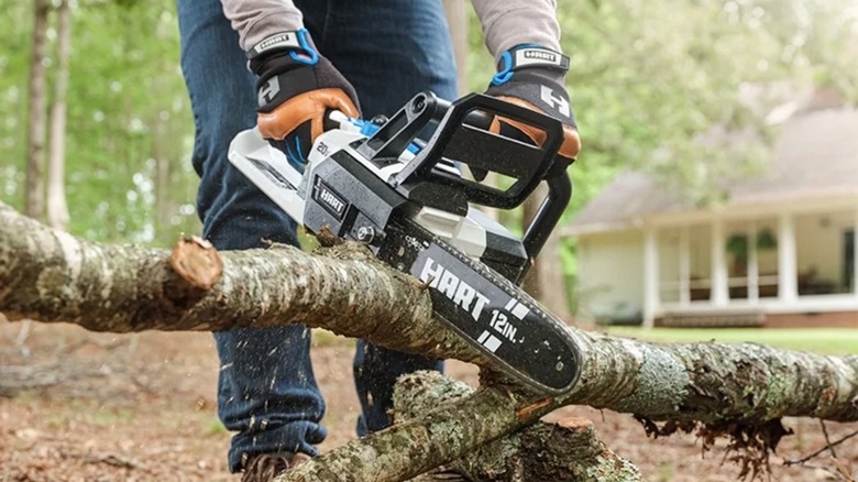 Person using Hart chainsaw