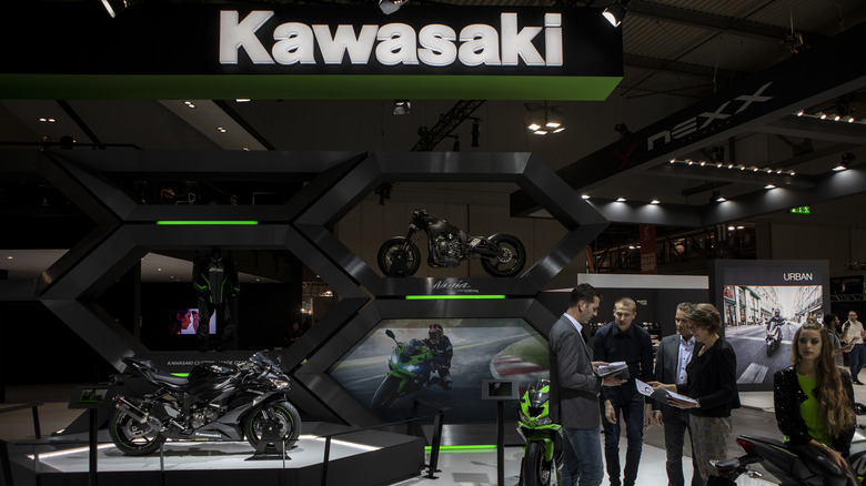 Motorcycles and attendees at the Kawasaki stand at the 76th edition of EICMA