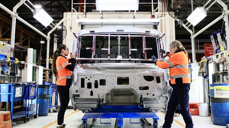 Workers assembling Kenworth truck in factory