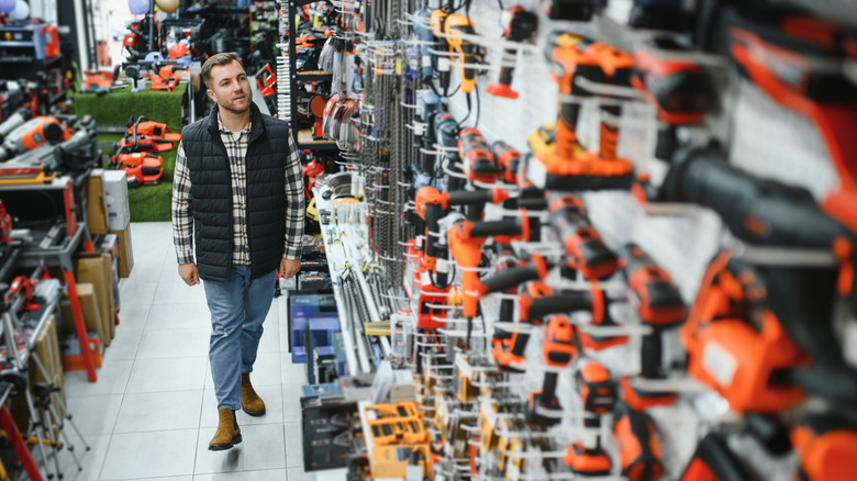 A man browsing power tools at a store