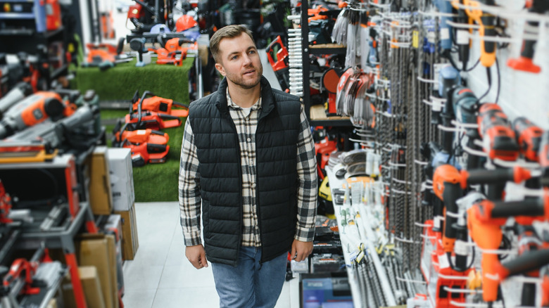 A man browsing power tools at a store