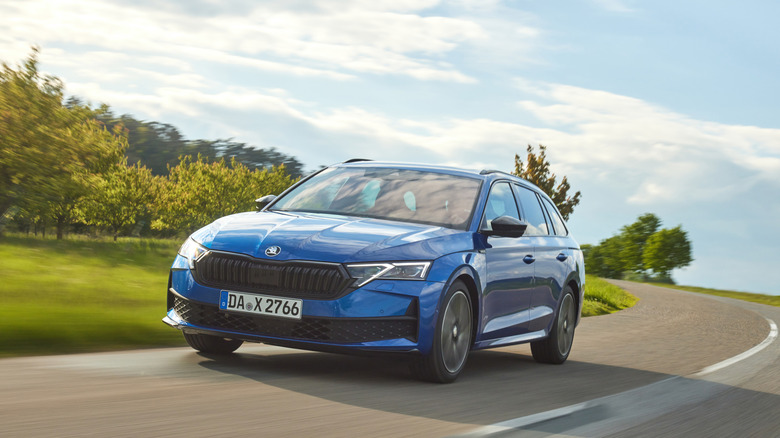 2025 Škoda Octavia Sportline driving on country road, front-left view