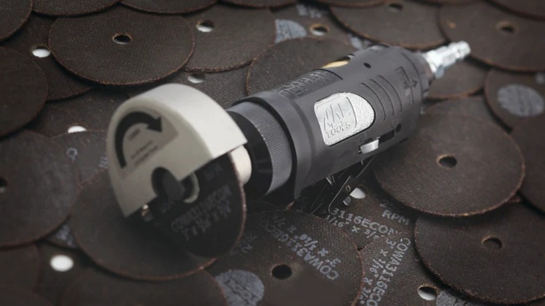 A Mac Tools cut-off tool on its side.