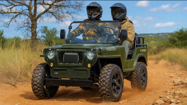 Two people driving a Massimo go cart jeep through the desert