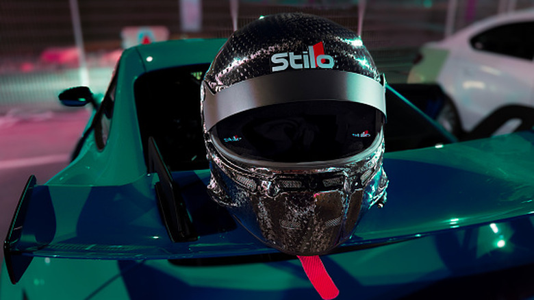A Stilo helmet perched on the back of a race car