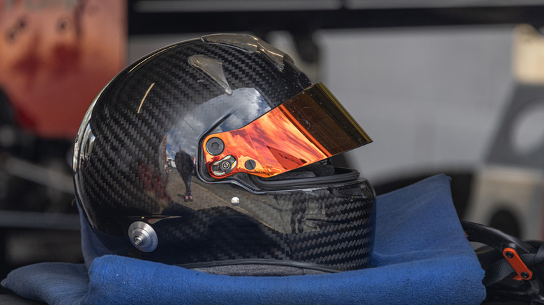 A black Stilo racing helmet shown sitting on top of a towel
