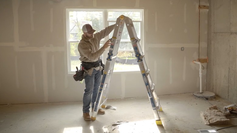A WernerCo ladder being used at a jobsite by a construction worker