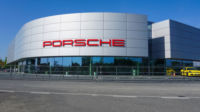 The outside of a Porsche dealership on a sunny day