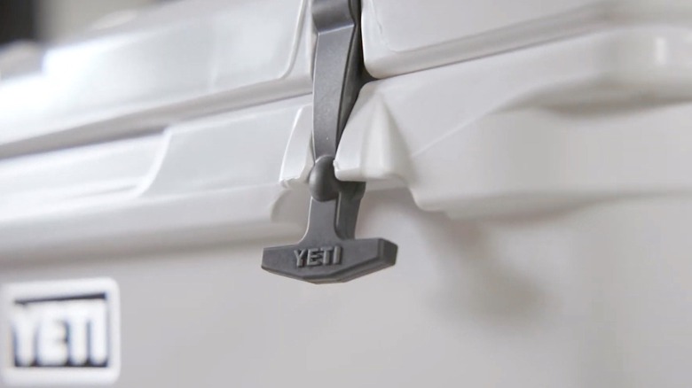 Yeti branded latch holding the lid of a cooler closed