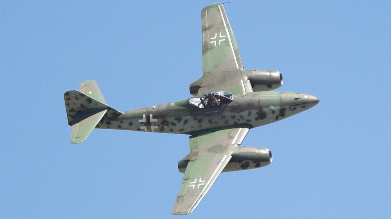 the Me 262 flies against a blue sky